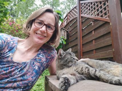 Portrait einer Frau mit Katze im Garten 