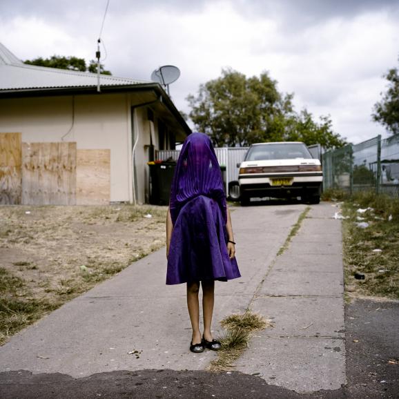 Moree, New South Wales, Australia: Laurinda waits in her purple dress for the bus that will take her to Sunday School.