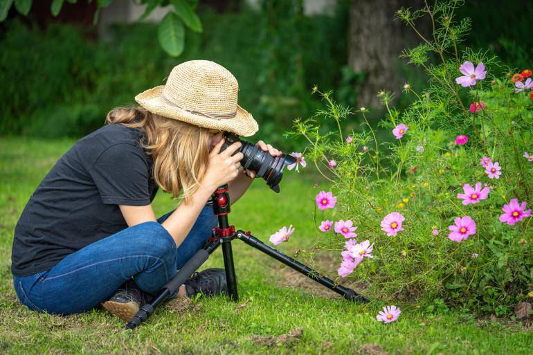 Fotografin arbeitet bodennah mit Stativ.